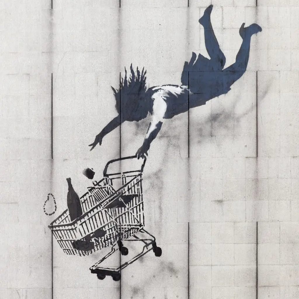 Banksy's Shop Until You Drop, a stencilled woman falling from a building clutching a shopping trolley.